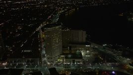 5K aerial stock footage fly over Harrah's and The Westin Canal Place to approach French Quarter at night, Louisiana Aerial Stock Footage | AX62_044