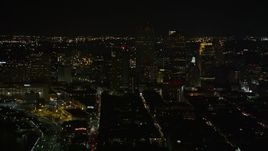 5K aerial stock footage of Downtown New Orleans at night, seen from the French Quarter, Louisiana Aerial Stock Footage | AX63_004E