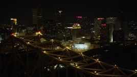 5K aerial stock footage orbit top of Crescent City Connection Bridge at night to reveal Downtown New Orleans, Louisiana Aerial Stock Footage | AX63_016