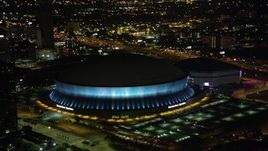 5K aerial stock footage orbit the Superdome as it changes colors at night, New Orleans, Louisiana Aerial Stock Footage | AX63_020