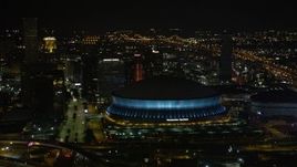 5K aerial stock footage orbit the Superdome as it changes colors at night, New Orleans, Louisiana Aerial Stock Footage | AX63_020E