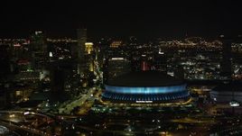 5K aerial stock footage of the Superdome and Downtown New Orleans skyscrapers at night, Louisiana Aerial Stock Footage | AX63_021