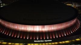 5K aerial stock footage of Mercedes-Benz Superdome with orange lighting at night, Downtown New Orleans, Louisiana Aerial Stock Footage | AX63_023