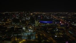 5K aerial stock footage of a reverse view  Superdome and Downtown New Orleans at night in Louisiana Aerial Stock Footage | AX63_027