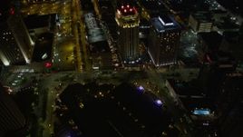 5K aerial stock footage of a bird's eye view of the French Quarter, including Bourbon Street, at night, and reveal Downtown New Orleans, Louisiana Aerial Stock Footage | AX63_029E