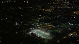 5K aerial stock footage fly over homes to approach Harrell Stadium at night, Carrollton, New Orleans, Louisiana Aerial Stock Footage | AX63_035
