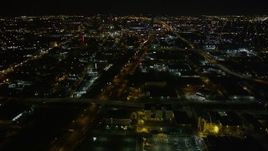 5K aerial stock footage approach Xavier University, pan to follow I-10 toward Superdome and downtown at night in Mid-City New Orleans, Louisiana Aerial Stock Footage | AX63_037E