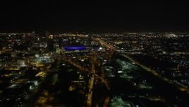 5K aerial stock footage follow Interstate 10 to the interchange and the Superdome at night in Downtown New Orleans, Louisiana Aerial Stock Footage | AX63_039