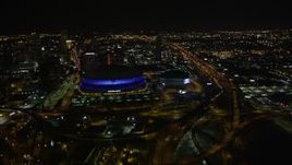 5K aerial stock footage follow Interstate 10 to the interchange and the Superdome at night in Downtown New Orleans, Louisiana Aerial Stock Footage | AX63_039E