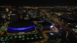 5K aerial stock footage fly over the I-10 and Highway 90 interchange to approach Superdome in Downtown New Orleans, Louisiana at night Aerial Stock Footage | AX63_040