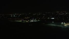 5K aerial stock footage of civilian plane taxiing at New Orleans Lakefront Airport at night, Louisiana Aerial Stock Footage | AX63_050