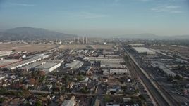 5K aerial stock footage fly over homes and warehouses to approach power plant smoke stacks, Sun Valley and Pacoima, California Aerial Stock Footage | AX64_0044
