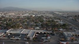 5K aerial stock footage of fly over homes to approach warehouses and power plant in Pacoima and Sun Valley, California Aerial Stock Footage | AX64_0048