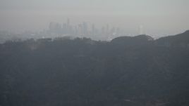 5K aerial stock footage of Downtown Los Angeles skyline shrouded in haze, California Aerial Stock Footage | AX64_0067