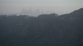 5K aerial stock footage of hazy Downtown Los Angeles skyline seen from Hollywood Hills, California Aerial Stock Footage | AX64_0068