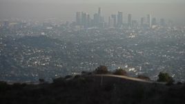 5K aerial stock footage fly over the Hollywood Hills to reveal Downtown Los Angeles and city sprawl, California Aerial Stock Footage | AX64_0070E