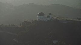 5K aerial stock footage flyby the Griffith Observatory in haze, Los Angeles, California Aerial Stock Footage | AX64_0072E