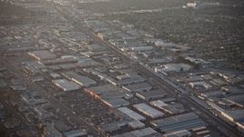 5K aerial stock footage of warehouses and Sherman Way Square mall beside train tracks in North Hollywood, California, sunset Aerial Stock Footage | AX64_0133E