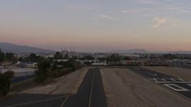 5K aerial stock footage of lifting off from Whiteman Airport runway, Pacoima, California, Sunset Aerial Stock Footage | AX64_0142E