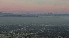 5K aerial stock footage of Santa Susana Mountains and neighborhoods in San Fernando Valley, Los Angeles, California, twilight Aerial Stock Footage | AX64_0158