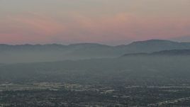 5K aerial stock footage of San Gabriel Mountains from across the San Fernando Valley, Los Angeles, California, twilight Aerial Stock Footage | AX64_0159