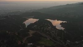 5K aerial stock footage of Hollywood Reservoir and Mulholland Dam in Los Angeles, California, twilight Aerial Stock Footage | AX64_0168