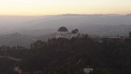 5K aerial stock footage of reverse view of the Griffith Observatory, Los Angeles, California, twilight Aerial Stock Footage | AX64_0173