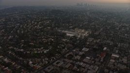 5K aerial stock footage of apartment buildings and urban homes, reveal Downtown Los Angeles skyline, Los Feliz, California, twilight Aerial Stock Footage | AX64_0174E