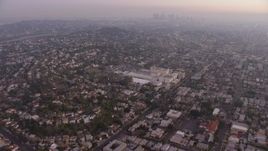 5K aerial stock footage tilt from urban homes in Los Feliz, reveal Downtown Los Angeles, California, twilight Aerial Stock Footage | AX64_0175