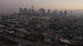 5K aerial stock footage approach Downtown Los Angeles skyline in haze, California, twilight Aerial Stock Footage | AX64_0185