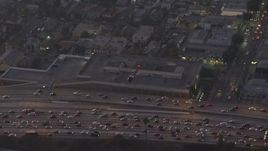 5K aerial stock footage of a police helicopter flying over 110 freeway traffic in Downtown Los Angeles, California, twilight Aerial Stock Footage | AX64_0199