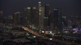 5K aerial stock footage of heavy traffic on 110 freeway and Downtown Los Angeles skyscrapers, California, twilight Aerial Stock Footage | AX64_0236