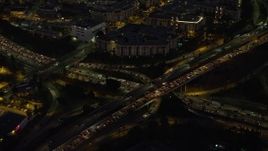 5K aerial stock footage of heavy traffic on Highway 110 and 101 interchange, Downtown Los Angeles, California, Night Aerial Stock Footage | AX64_0252