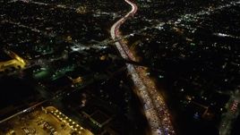5K aerial stock footage tilt from Highway 101 to reveal the Downtown Los Angeles skyline, California. night Aerial Stock Footage | AX64_0340