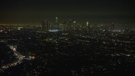 5K aerial stock footage of a view of the Downtown Los Angeles skyline and city sprawl, California, night Aerial Stock Footage | AX64_0344