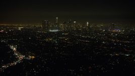 5K aerial stock footage of flying by the Downtown Los Angeles skyline and city sprawl, California, night Aerial Stock Footage | AX64_0345