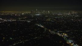 5K aerial stock footage of flying by the Downtown Los Angeles skyline and city sprawl, California, night Aerial Stock Footage | AX64_0345E