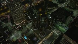 5K aerial stock footage tilt to bird's eye of Westin Bonaventure Hotel and city streets, Downtown Los Angeles, California, night Aerial Stock Footage | AX64_0394