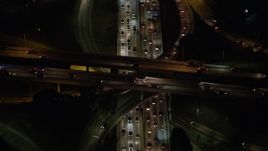 5K aerial stock footage tilt to a bird's eye view of cars on the 110 and 101 interchange, Downtown Los Angeles, California, night Aerial Stock Footage | AX64_0398