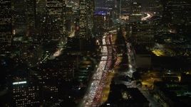 5K aerial stock footage tilt to heavy traffic on Highway 110, Downtown Los Angeles, California, night Aerial Stock Footage | AX64_0402