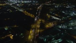 5K aerial stock footage tilt from Interstate 5 with light traffic to warehouses and homes, Sun Valley, California, night Aerial Stock Footage | AX64_0439E