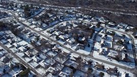 4.8K aerial stock footage of a snow covered neighborhood in Plainview, New York Aerial Stock Footage | AX66_0007E