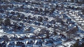 4.8K aerial stock footage of a snow covered neighborhood, Plainview, New York Aerial Stock Footage | AX66_0009E