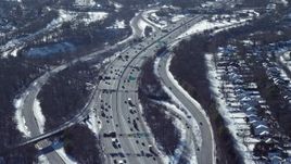 4.8K aerial stock footage of an interstate by homes in snow, Jericho, New York Aerial Stock Footage | AX66_0015