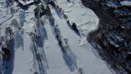 4.8K aerial stock footage of a country road by bare trees in snow, reveal mansions, Old Westbury, New York Aerial Stock Footage | AX66_0020E