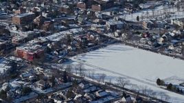 4.8K aerial stock footage of a residential neighborhood and sports field in snow, Great Neck, New York Aerial Stock Footage | AX66_0033E