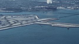 4.8K aerial stock footage track passenger jet landing LaGuardia Airport, New York Aerial Stock Footage | AX66_0043E