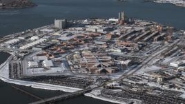 4.8K aerial stock footage of flying by prison buildings Rikers Island Prison in snow, New York Aerial Stock Footage | AX66_0050