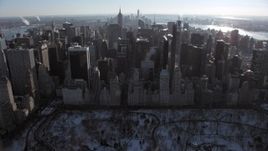 4.8K aerial stock footage tilt from Central Park to reveal Midtown Manhattan in winter, New York City Aerial Stock Footage | AX66_0107