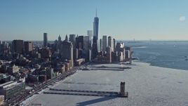 4.8K aerial stock footage of the World Trade Center skyline beside Hudson River with ice, New York City Aerial Stock Footage | AX66_0117E
